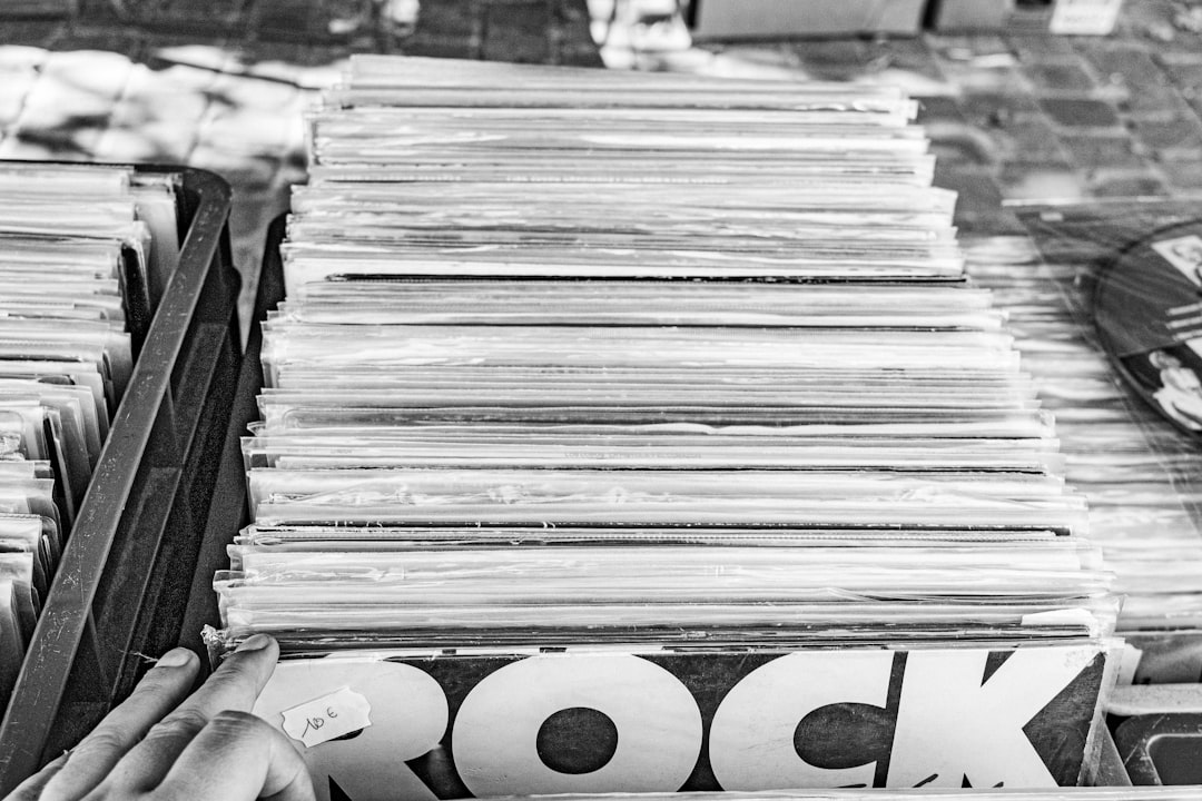 Black-and-white image of a record store album bin. Photo by Nicolas Denorme on Unsplash